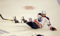 CHICAGO, IL - JANUARY 02: Taylor Hall #4 of the Edmonton Oilers slides across the ice after falling against the Chicago Blackhawks at the United Center on January 2, 2012 in Chicago, Illinois. (Photo by Jonathan Daniel/Getty Images)