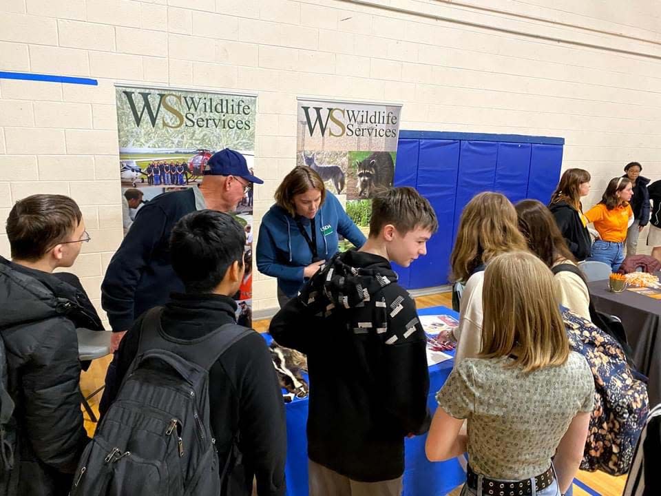 USDA Wildlife Services Specialist Jim Evans and District Supervisor Erin Patrick gather a crowd while talking opportunities in wildlife services.