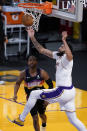 Los Angeles Lakers forward Anthony Davis, right, reaches for a rebound over Phoenix Suns guard Chris Paul during the first half of an NBA basketball game Sunday, May 9, 2021, in Los Angeles. (AP Photo/Marcio Jose Sanchez)