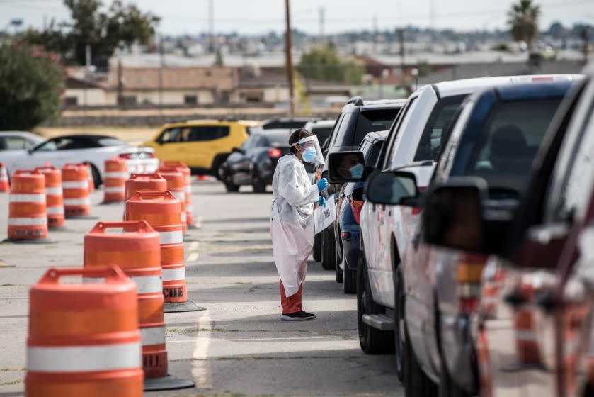 EL PASO, TX - OCTOBER 31: An attendant talks to a person waiting in their car at a coronavirus testing site at Ascarate Park on October 31, 2020 in El Paso, Texas. As El Paso reports record numbers of active coronavirus cases, the Texas Attorney General sues to block local shutdown orders. (Photo by Cengiz Yar/Getty Images)