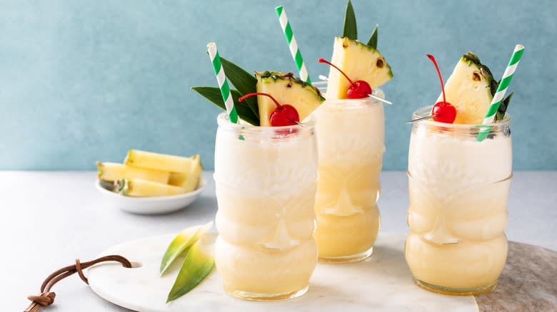 piña coladas in tiki glasses