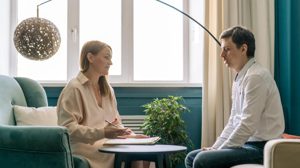 Female therapist talking to a male client