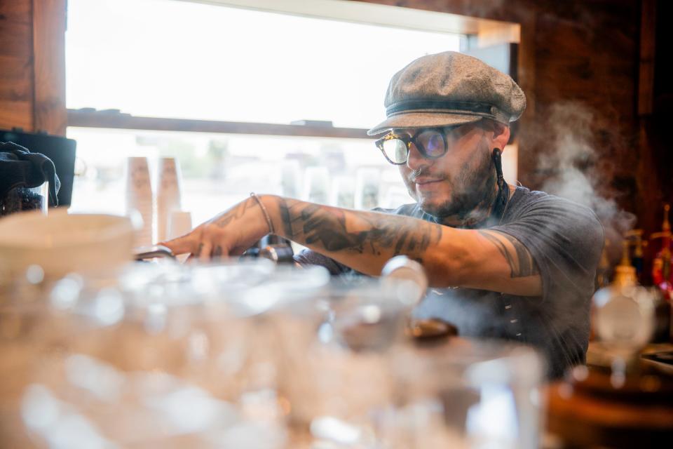 Johnny Rios prepares an order inside The Coffee Builders in Phoenix on Aug. 9, 2023.