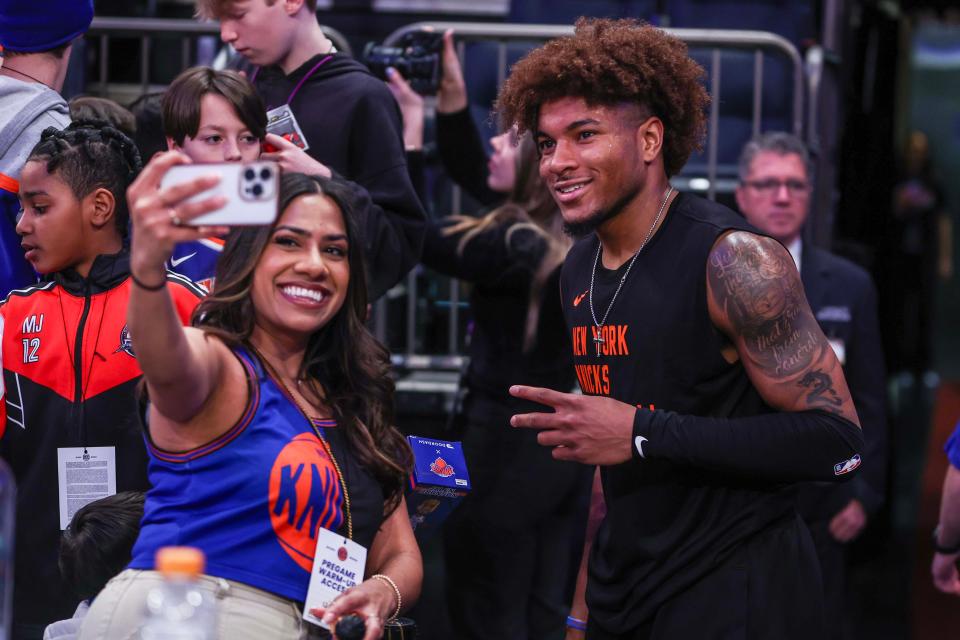 Apr 14, 2024; New York, New York, USA; New York Knicks guard Miles McBride (2) poses with a fan prior to the game against the Chicago Bulls at Madison Square Garden. Mandatory Credit: Wendell Cruz-USA TODAY Sports