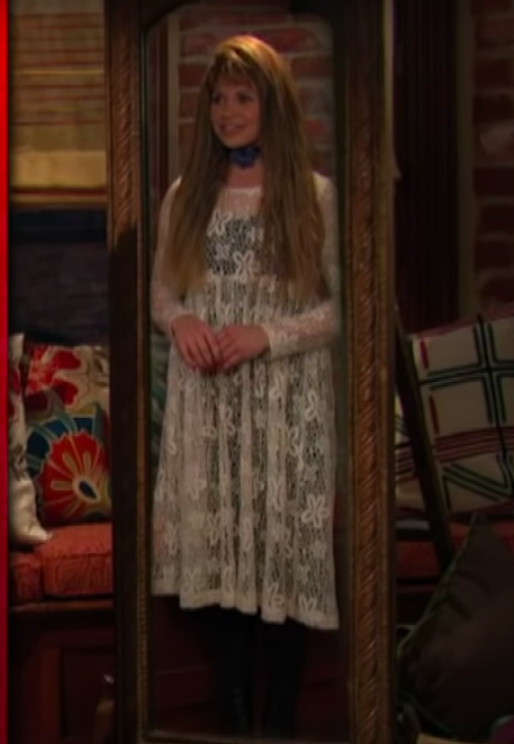 Topanga wearing a transparent lacy long-sleeved dress