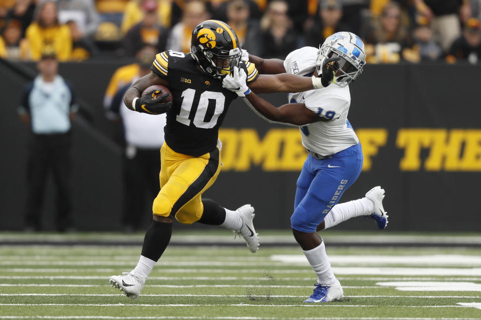 Iowa running back Mekhi Sargent (10) tries to break a tackle by Middle Tennessee cornerback Teldrick Ross, right, during the first half of an NCAA college football game, Saturday, Sept. 28, 2019, in Iowa City, Iowa. (AP Photo/Charlie Neibergall)