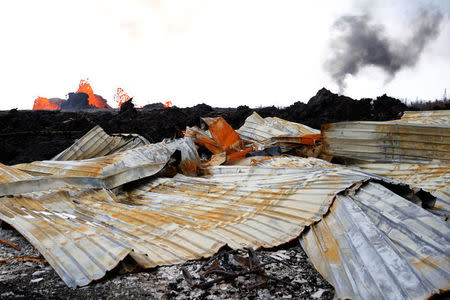 A destroyed structure is seen as lava pours out of a fissure, in Leilani Estates near Pahoa, Hawaii, U.S., May 26, 2018. REUTERS/Marco Garcia