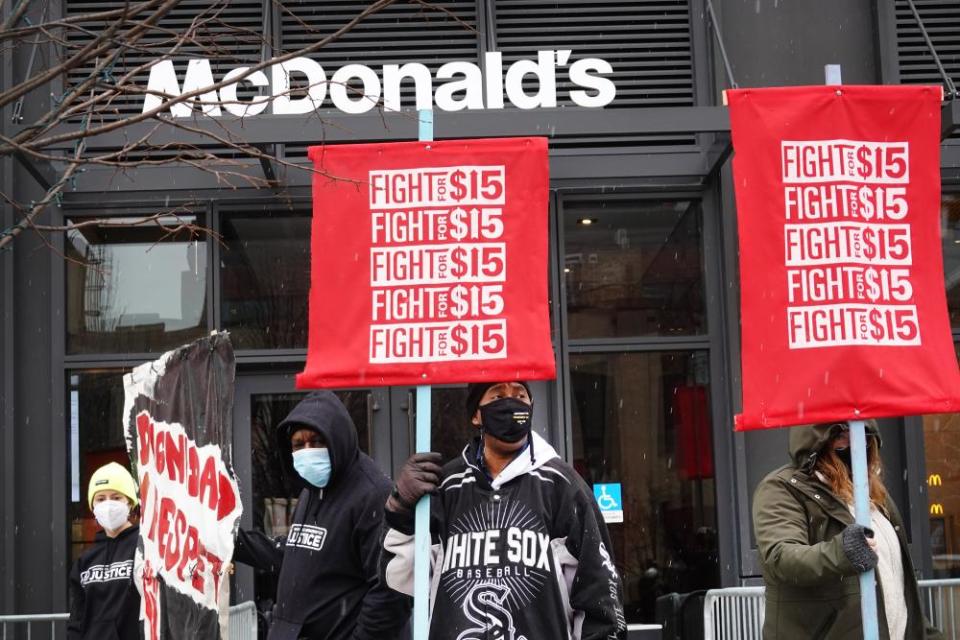 People take part in a demonstration to raise the minimum wage outside of McDonald’s corporate headquarters in Chicago on 15 January.