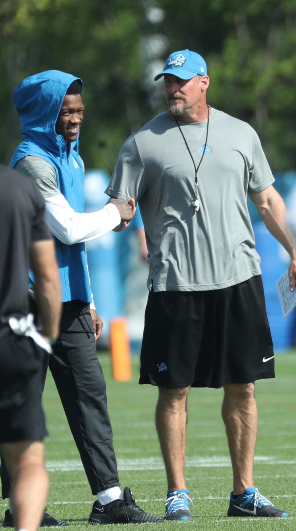 Detroit Lions head coach Dan Campbell talks with injured wide receiver Jameson Williams during joint practice with the Jacksonville Jaguars in Allen Park, Thursday, Aug. 17, 2023.