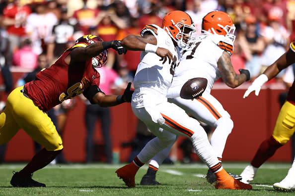 LANDOVER, MARYLAND – OCTOBER 06: Deshaun Watson #4 of the Cleveland Browns avoids a tackle by Dorance Armstrong #92 of the Washington Commanders during the first quarter at Northwest Stadium on October 06, 2024 in Landover, Maryland. (Photo by Timothy Nwachukwu/Getty Images)