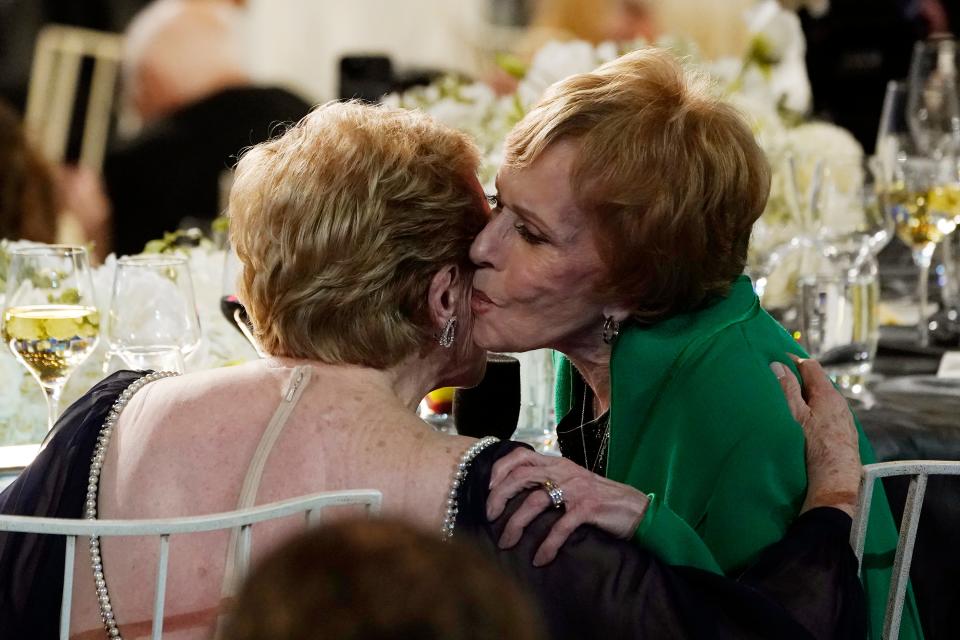 Comedian Carol Burnett, right, kisses actor Julie Andrews at the 48th AFI Life Achievement Award Gala honoring Andrews on June 9 at the Dolby Theatre in Los Angeles.