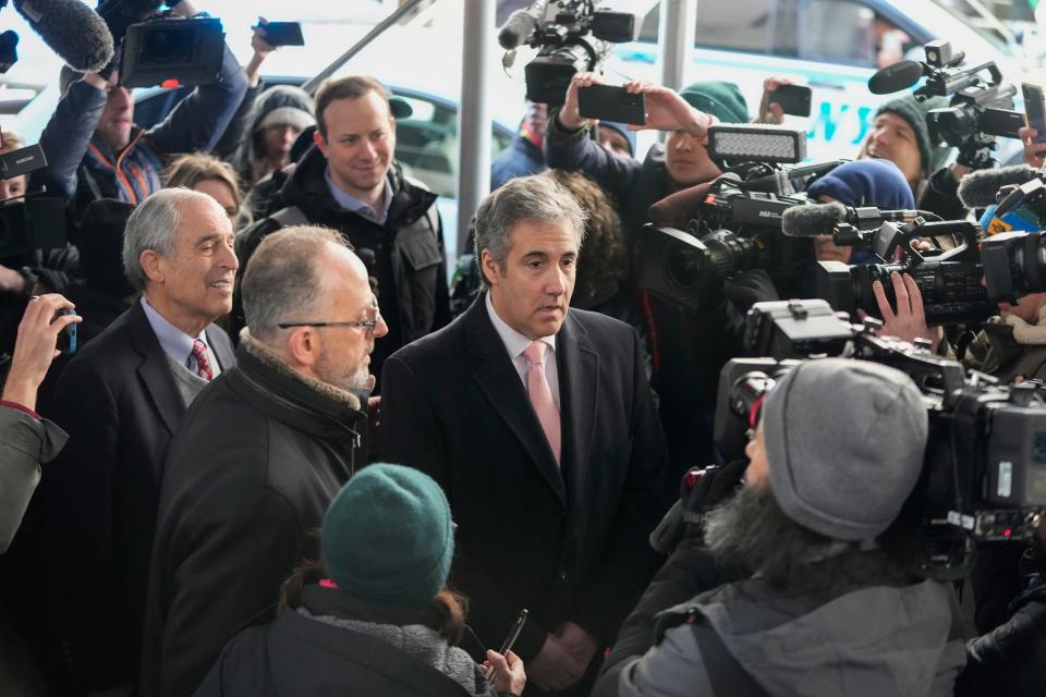 Michael Cohen surrounded by reporters and people with cameras.