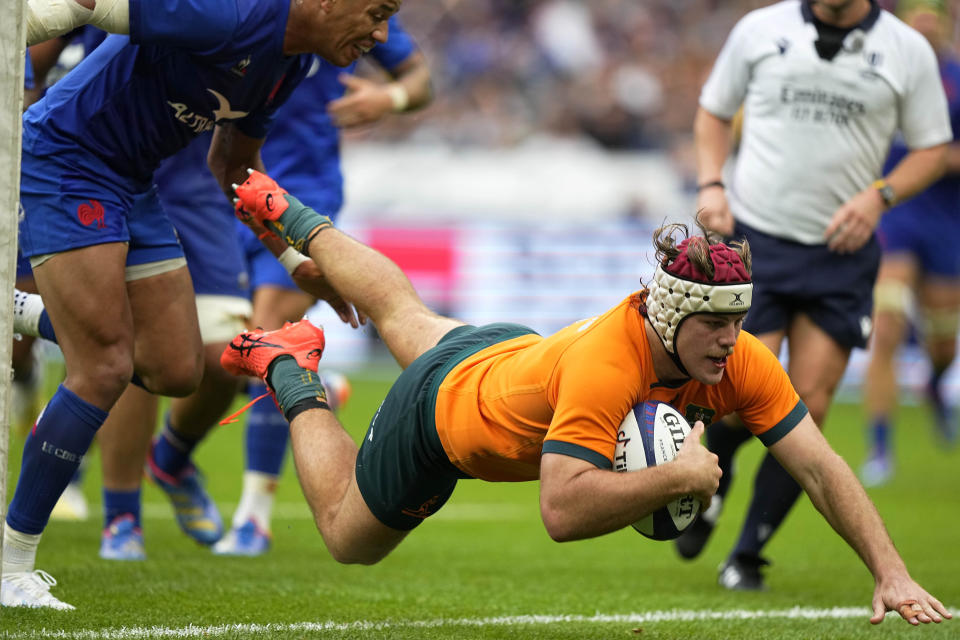 Australia's Fraser McReight scores a try during the International Rugby Union World Cup warm-up match between France and Australia at the Stade de France stadium in Saint Denis, outside Paris, Sunday, Aug. 27, 2023. (AP Photo/Michel Euler)