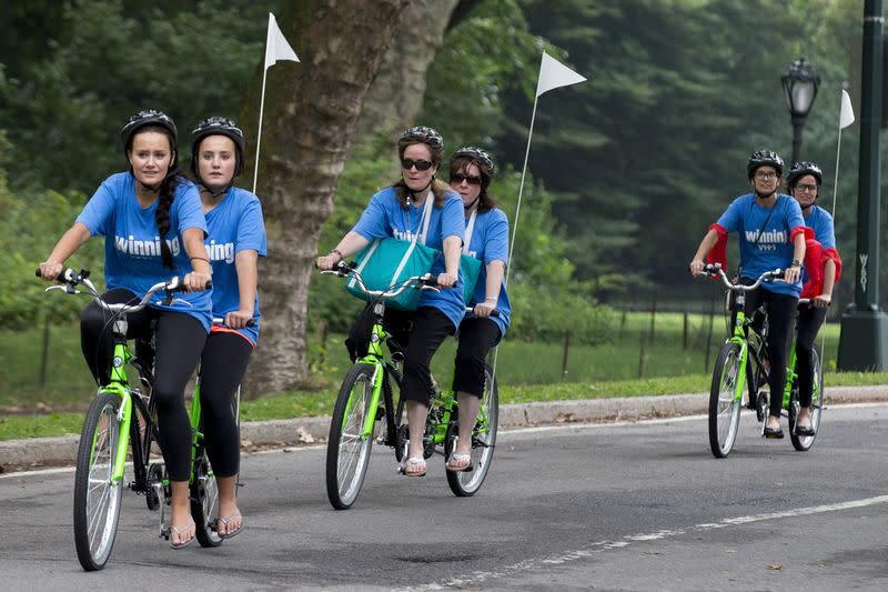 FILE PHOTO: Sets of twins ride on tandem bicycles in New York's Central Park