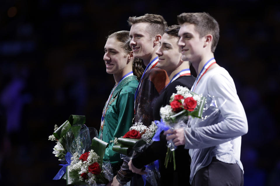 The top four men's skaters, from left, Jason Brown, second place; Jeremy Abbott, first place; Max Aaron, third place, and Joshua Farris pose on the awards stand at the medals ceremony at the U.S. Figure Skating Championships in Boston, Sunday, Jan. 12, 2014. (AP Photo/Steven Senne)