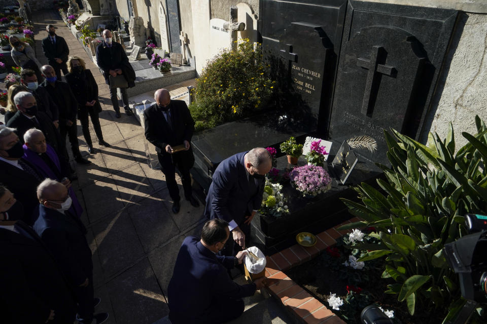Prince Albert II of Monaco fills an urn with Monaco soil in front of Josephine Baker's grave, during a ceremony held at the Monaco-Louis II Cemetery in Monaco, Monday, Nov. 29, 2021. France is inducting Missouri-born cabaret dancer Josephine Baker who was also a French World War II spy and civil rights activist into its Pantheon. She is the first Black woman honored in the final resting place of France’s most revered luminaries. A coffin carrying soils from places where Baker made her mark will be deposited Tuesday inside the domed Pantheon monument overlooking the Left Bank of Paris. (AP Photo/Daniel Cole)