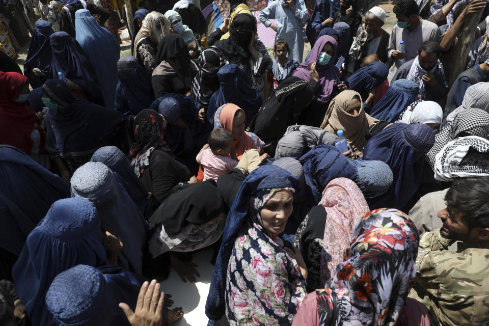 Internally displaced Afghans from northern provinces, who fled their home due to fighting between the Taliban and Afghan security personnel, wait to receive free food in a public park in Kabul, Afghanistan, Tuesday, Aug. 10, 2021. (AP Photo/Rahmat Gul)