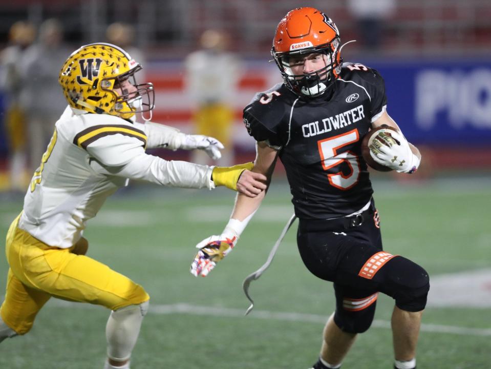 Coldwater's Marcel Blasingame carries the ball in a Division VI state semifinal win over West Jefferson in 2021.