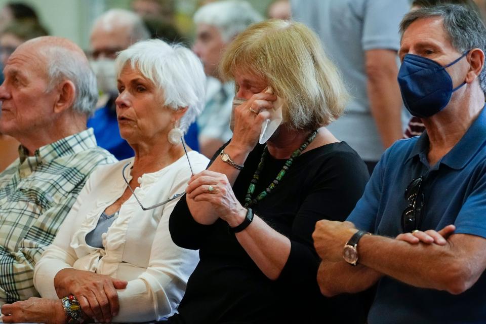 Jul 3, 2022; Columbus, Ohio, USA;  Parishioners listen to a video taped message from Rev. Rene Costanza at the Newman Center, the parish and student ministry at Ohio State, letting them know that the diocese is being taken from the Paulist fathers during Catholic mass on July 3, 2022. Mandatory Credit: Adam Cairns-The Columbus Dispatch