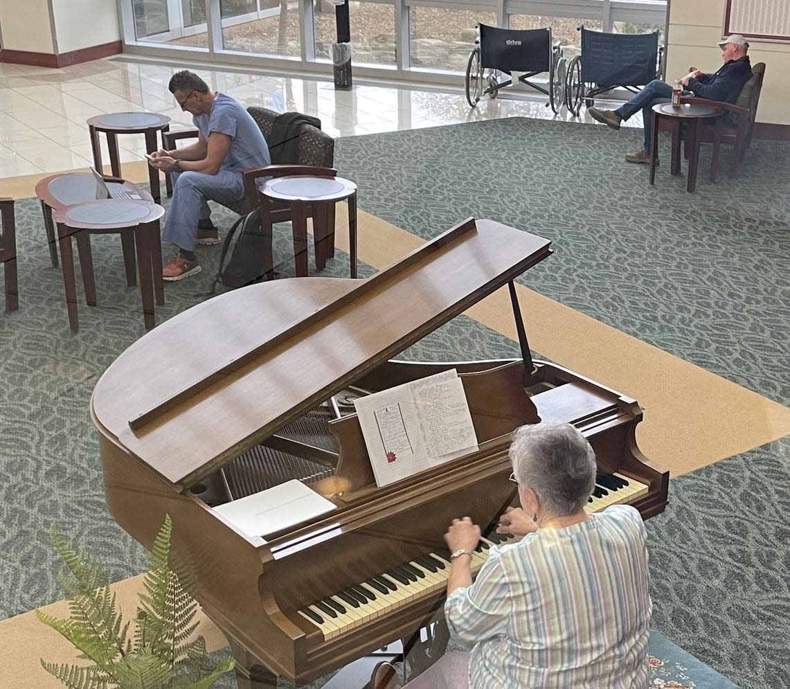 Dottie Rood plays the piano in the lobby of Aultman Hospital in Canton.