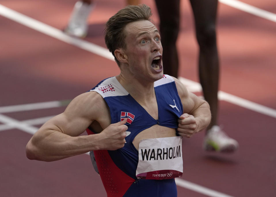 Karsten Warholm, of Norway celebrates as he wins the gold medal in the final of the men's 400-meter hurdles at the 2020 Summer Olympics, Tuesday, Aug. 3, 2021, in Tokyo, Japan. (AP Photo/Charlie Riedel)