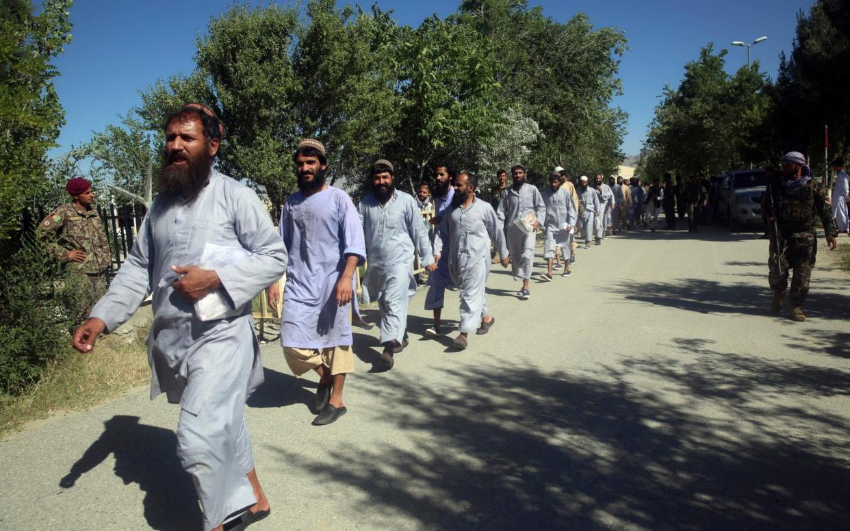 Afghan prisoners line up after their release from Bagram Prison in Parwan province, Afghanistan, Tuesday, May 26, 2020. - AFP