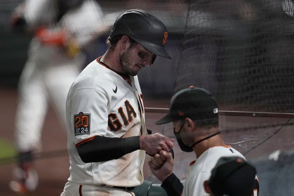 San Francisco Giants' Daniel Robertson, left, is congratulated by manager Gabe Kapler after scoring against the Colorado Rockies during the fifth inning of a baseball game in San Francisco, Tuesday, Sept. 22, 2020. (AP Photo/Jeff Chiu)