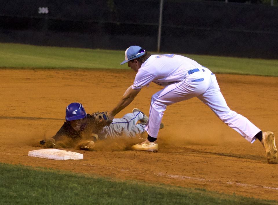 Burns' Colby Putnam applies the tag to a sliding Cherryville base runner during Thursday's Southern Piedmont 1A/2A tournament final.