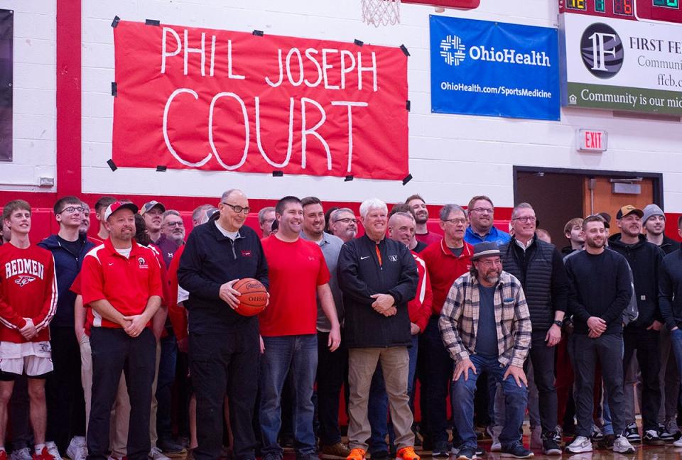 Bucyrus' Phil Joseph stands with former coaches and players who were in attendance for his pregame ceremony.