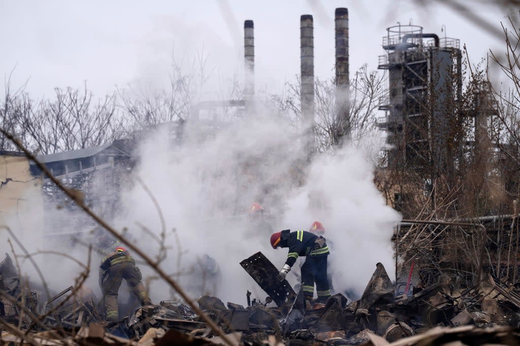 Ukrainian firefighters work at the scene of a destroyed building after shelling in Odesa (Petros Giannakouris/AP) (AP)