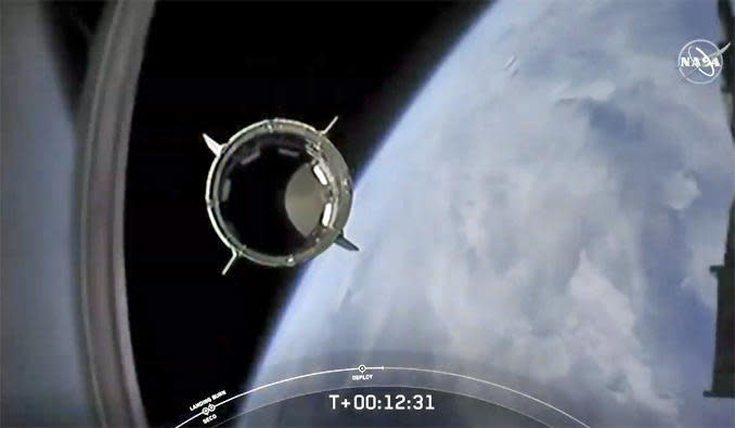 A camera on the Falcon 9's second stage captures a spectacular view of the Crew Dragon capsule separating and flying away on its own after reaching orbit. / Credit: SpaceX/NASA
