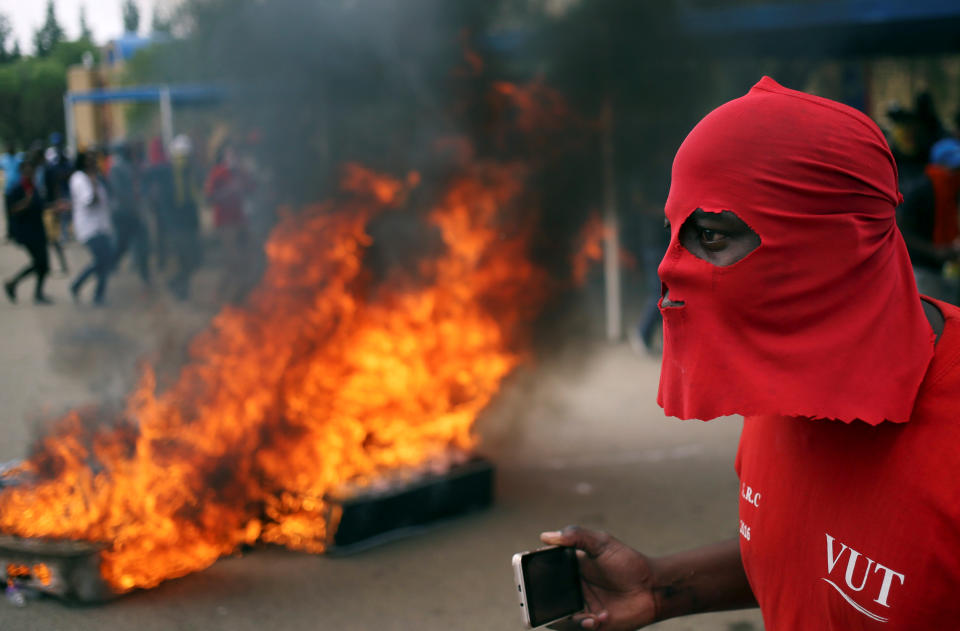 A protester looks on in front of a barricade during a protest demanding free education, at the Vaal University of Technology in Vanderbijlpark, South Africa, October 13, 2016. REUTERS/Siphiwe Sibeko      TPX IMAGES OF THE DAY     