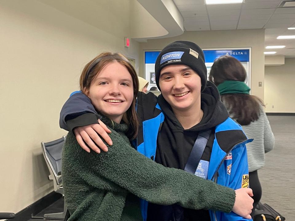 Adeline Albert, right, poses for a photo with fraternal twin Avah after returning to Columbus from South Korea on Friday.