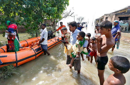 People are rescued from a flooded village in Motihari, Bihar State, India August 23, 2017. REUTERS/Cathal McNaughton