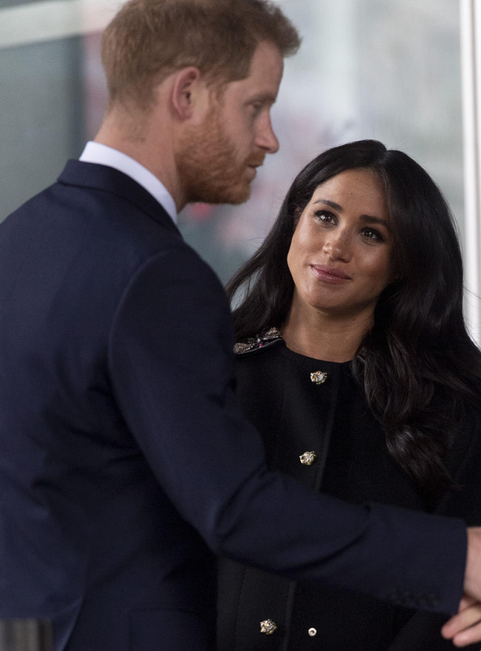 Meghan looks up at Harry during the stop on Tuesday. (Photo: Mark Cuthbert via Getty Images)