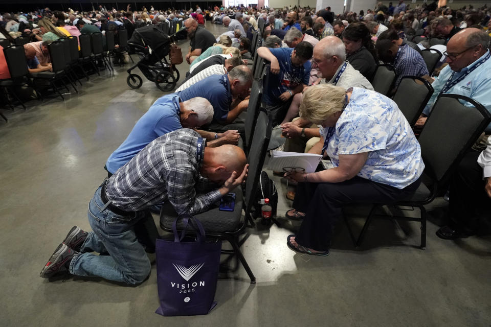 People pray during the annual Southern Baptist Convention meeting Tuesday, June 15, 2021, in Nashville, Tenn. (AP Photo/Mark Humphrey)