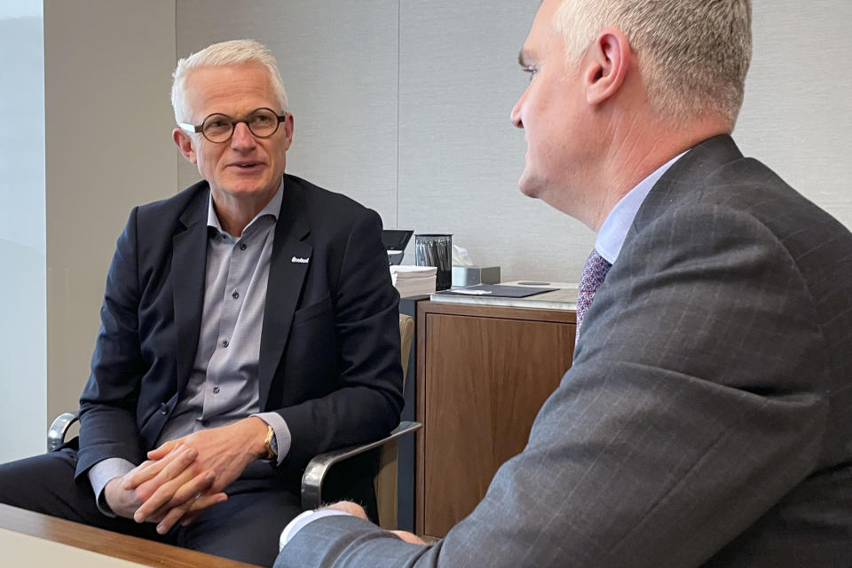 Mads Nipper, CEO of Orsted, left, speaks with David Hardy, CEO of the Orsted Americas region, while in New York on Tuesday, Feb. 28, 2023. Orsted, the former Danish Oil and Natural Gas company, ramped up construction of offshore wind farms beginning in 2008 and sold off the oil and gas side of the business in 2017. Now Orsted is a global leader in renewable energy. (AP Photo/Jennifer McDermott)