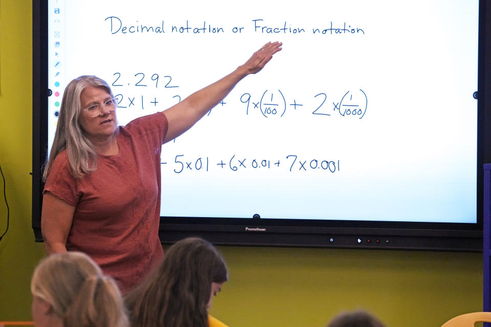 Elementary math teacher Margie Howells teaches a fifth grade class at Wheeling Country Day School in Wheeling, W.Va., on Tuesday, Sept. 5, 2023. Howells said that she turned to the science of math after wondering why there weren't as many resources for dyscalculia as there were for dyslexia. Reading the research helped her become more explicit about things that she assumed students understood, like the fact that the horizontal line in a fraction means the same thing as a division sign. "I'm doing a lot more instruction in vocabulary and symbol explanations so that the students have that built-in understanding," said Howells. (AP Photo/Gene J. Puskar)