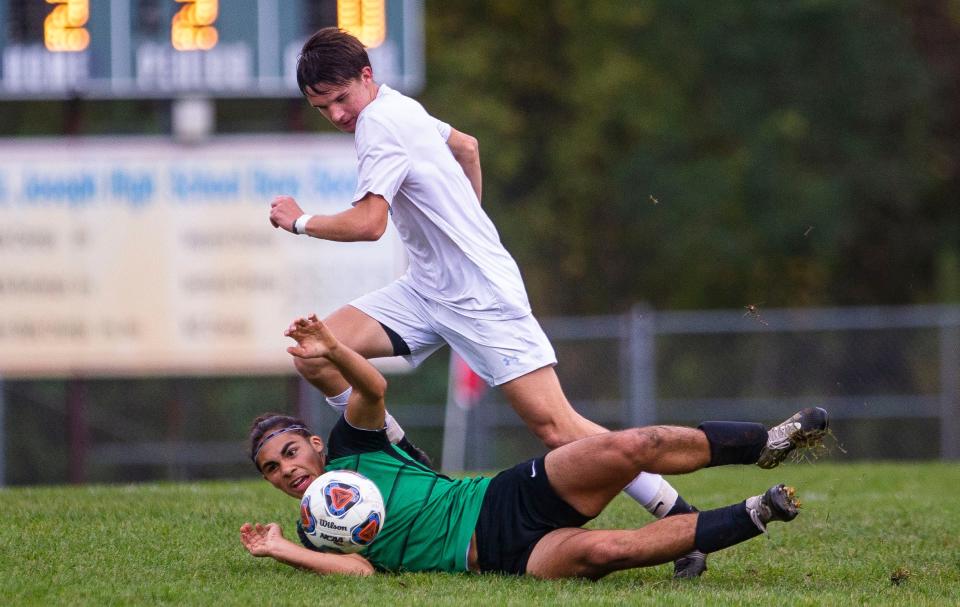 Saint Joseph's Trey Place tries to get past Bremen's Irubel Macias during the Bremen vs. Saint Joseph sectional semifinal soccer match Wednesday, Oct. 6, 2021 at the Northfield Athletic Complex in South Bend. 