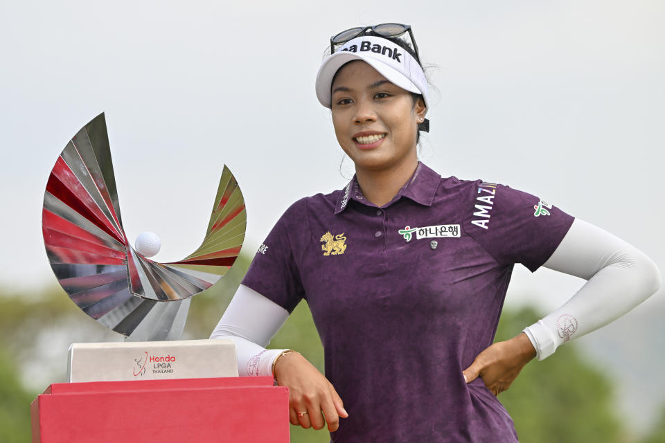 Patty Tavatanakit of Thailand poses for a photo with her trophy during the award ceremony after winning the LPGA Honda Thailand golf tournament in Pattaya, southern Thailand, Sunday, Feb. 25, 2024. (AP Photo/Kittinun Rodsupan)