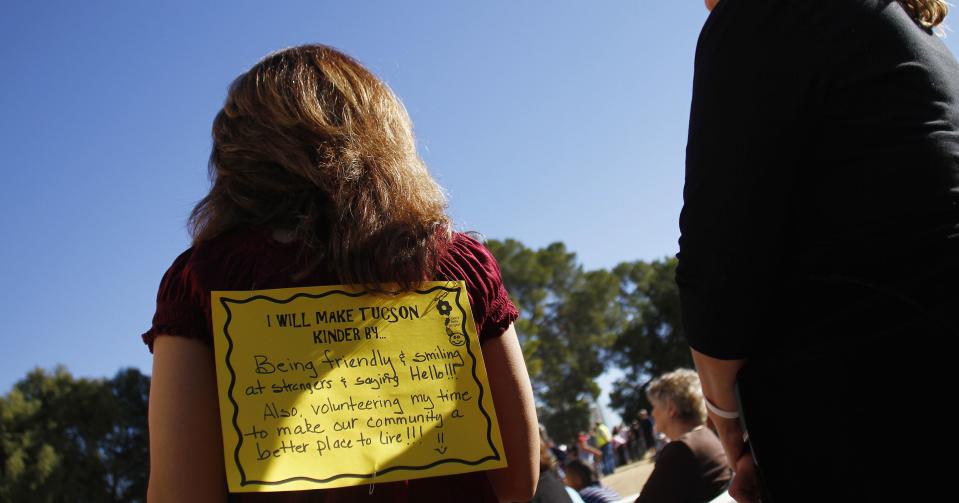 A woman wears a sign on her back at an event commemorating the one-year anniversary of the shooting. (Joshua Lott/Reuters)