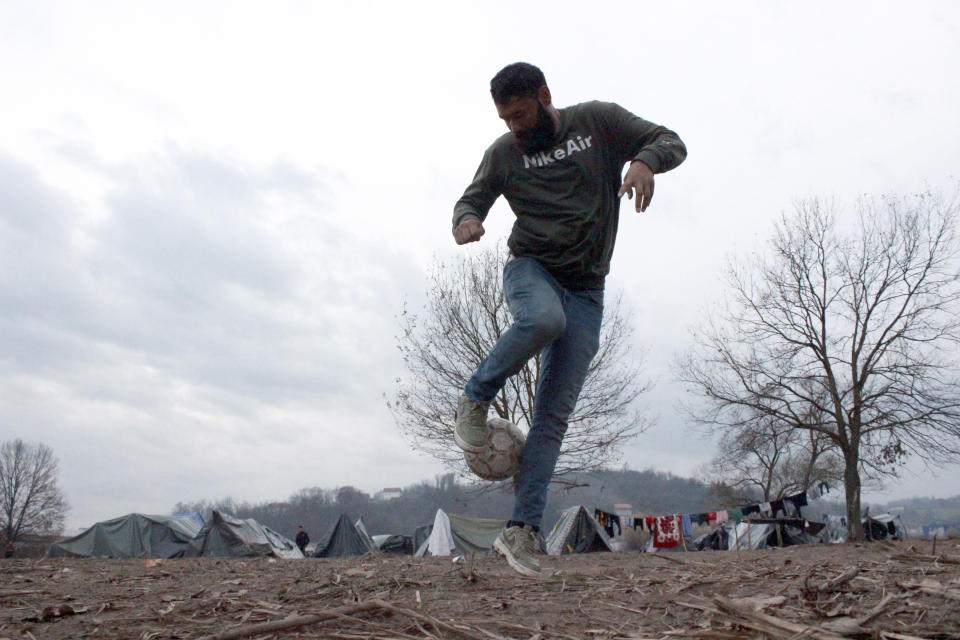 Ibrahim Rasool, Afghan refugee, formerly a FIFA-licensed futsal referee controls the ball at a makeshift camp housing migrants, in Velika Kladusa, Bosnia, Saturday, Nov. 13, 2021. Ibrahim Rasool loved his job as a futsal referee because of sportsmanship and fair play. But the 33-year-old man from Afghanistan says there is nothing fair about the way the European Union treats people seeking refuge from violence and war. (AP Photo/Edvin Zulic)