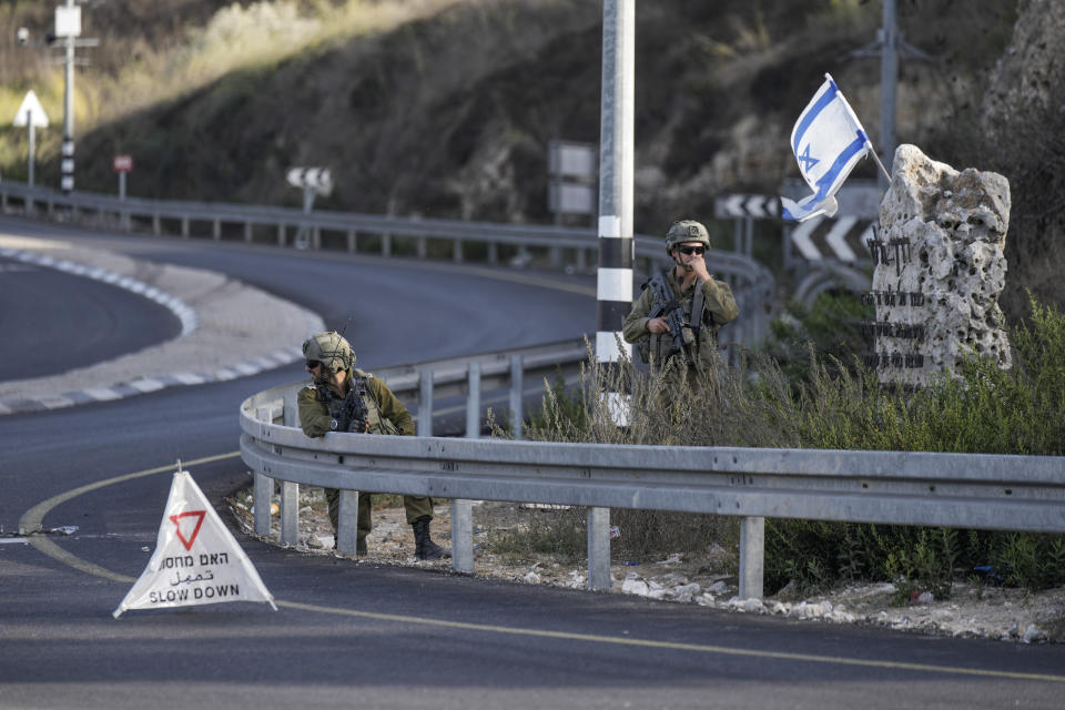 Israeli soldiers take position at a roadblock near the West Bank town of Nablus, Saturday, Sept. 24 2022. Israeli troops on Saturday shot and killed a Palestinian motorist who allegedly tried to ram his car into a group of soldiers patrolling in the occupied West Bank, according to Israeli soldiers and media. (AP Photo/Majdi Mohammed)