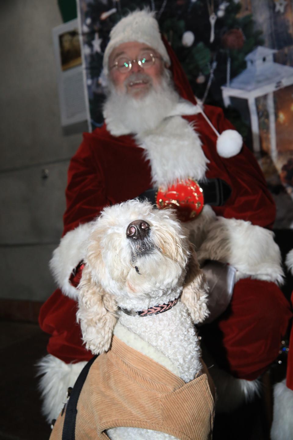 Oaklie Rose doing her best Snoopy imitation for Santa Claus.