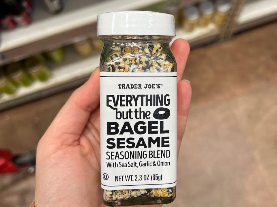 The writer holds a bottle of Trader Joe's Everything But the Bagel Seasoning