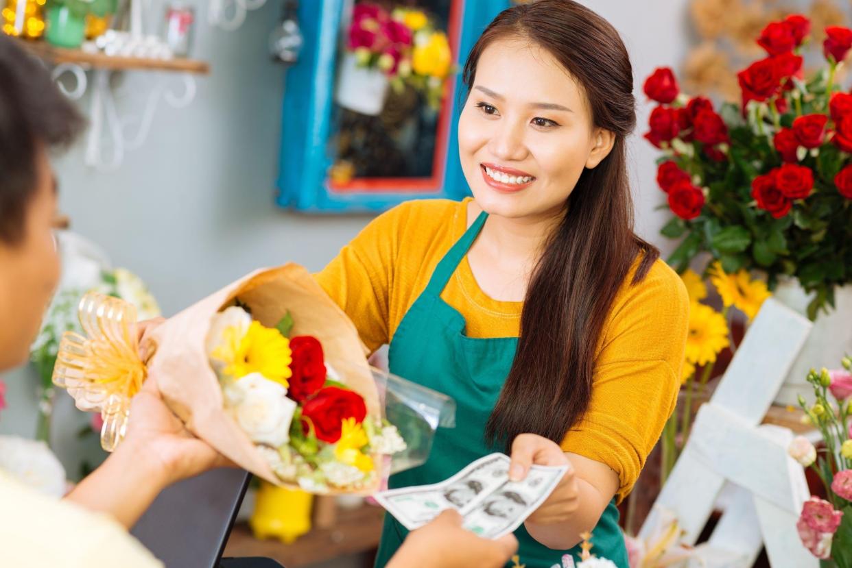 woman selling flowers to a man