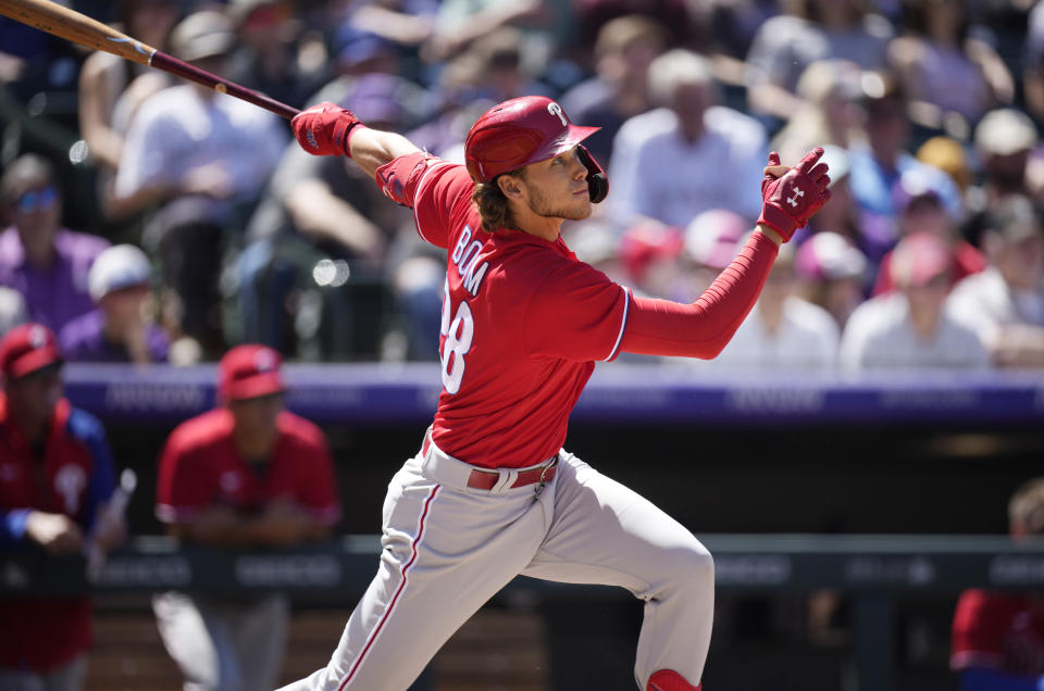 Philadelphia Phillies' Alec Bohm follows the flight of his two-run home run off Colorado Rockies starting pitcher German Marquez in the fourth inning of a baseball game Wednesday, April 20, 2022, in Denver. (AP Photo/David Zalubowski)