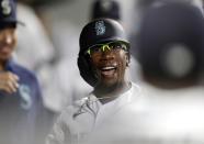 Seattle Mariners' Shed Long Jr. celebrates in the dugout after hitting a solo home run on a pitch from Colorado Rockies' Tyler Kinley during the eighth inning of a baseball game, Tuesday, June 22, 2021, in Seattle. (AP Photo/John Froschauer)
