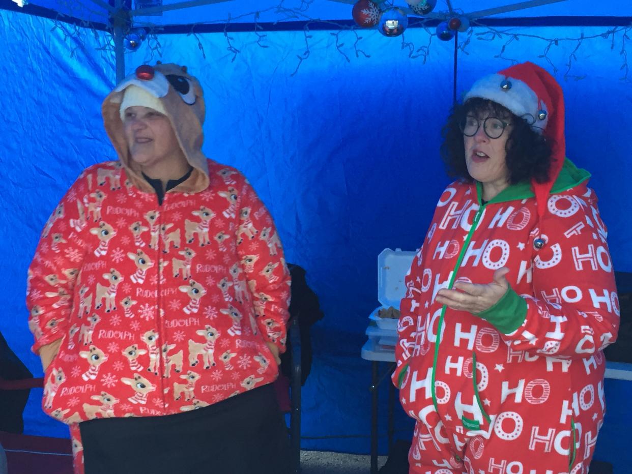 Joy Ritchie and Nancy Burkett man the Plymouth Cheesecake Lady booth at Christmas in the Village on Thursday.