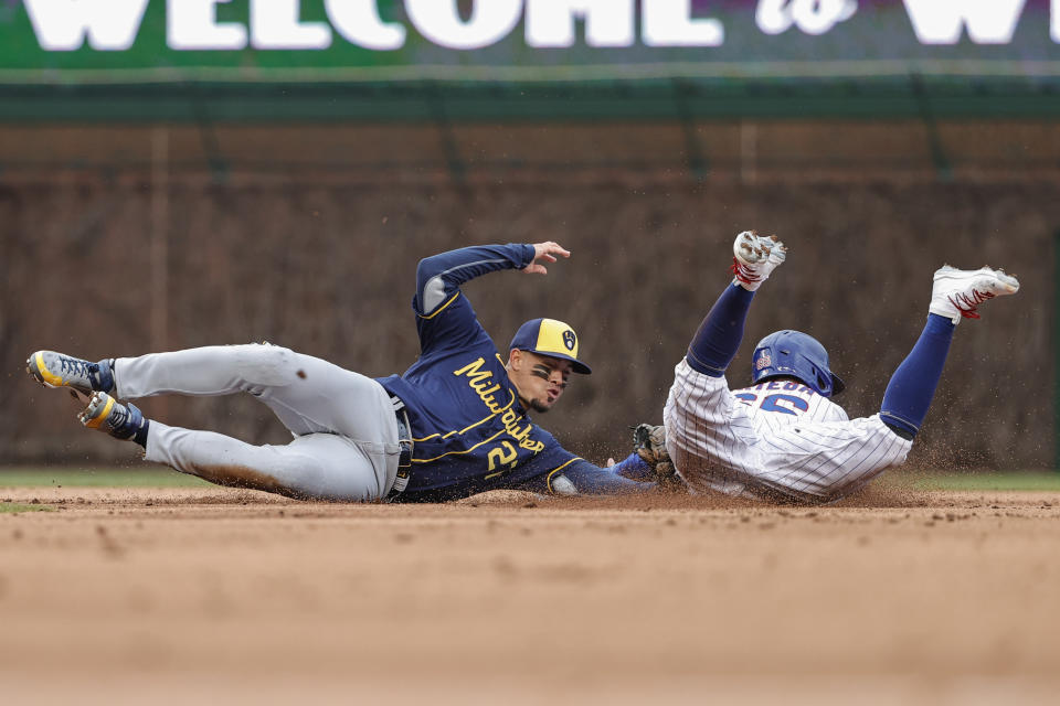 Milwaukee Brewers' Willy Adames, left, tags out Chicago Cubs' Rafael Ortega at second base during the first inning of a baseball game, Thursday, April 7, 2022, in Chicago. (AP Photo/Kamil Krzaczynski)